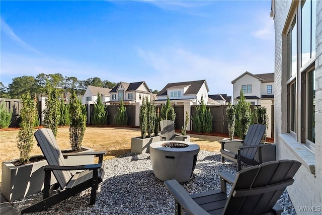 exterior space with a patio area, a fire pit, a residential view, and a fenced backyard