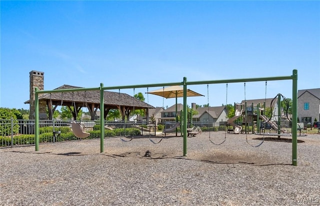 community jungle gym with a residential view and fence