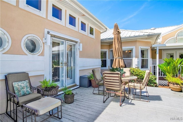 view of patio featuring a deck, french doors, and outdoor dining space