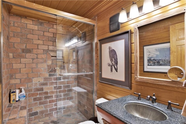 bathroom featuring wooden ceiling, wooden walls, a shower stall, and vanity