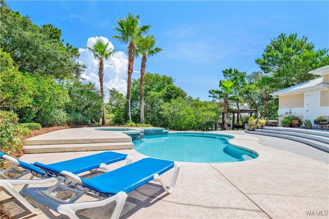 view of pool featuring a patio area and a pool with connected hot tub