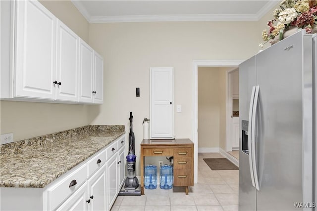 kitchen with white cabinets, light tile patterned floors, ornamental molding, and stainless steel refrigerator with ice dispenser