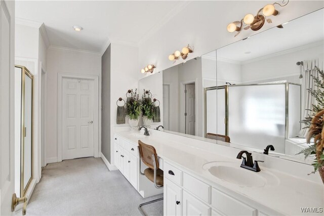 full bath featuring crown molding, a sink, and a shower stall