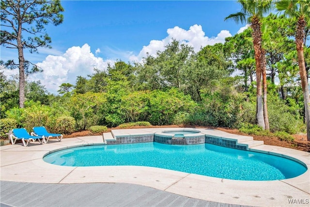 view of swimming pool with a patio area and a pool with connected hot tub