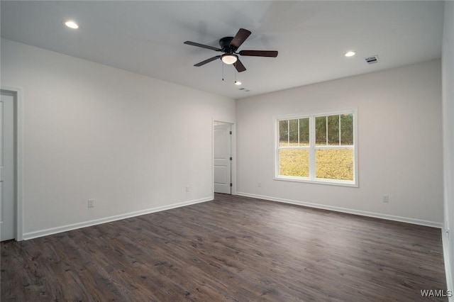 empty room with dark hardwood / wood-style floors and ceiling fan