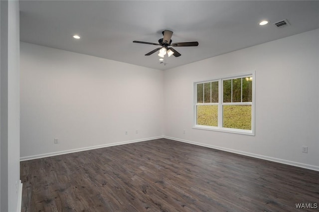 empty room featuring ceiling fan and dark wood-type flooring