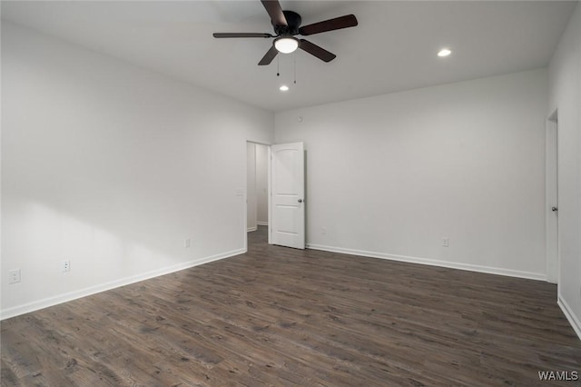 spare room with ceiling fan and dark wood-type flooring