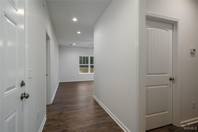 hallway with dark hardwood / wood-style floors