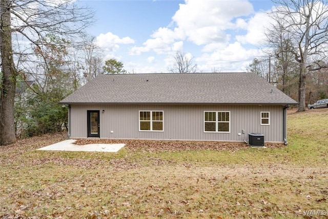 rear view of property with a yard and central AC