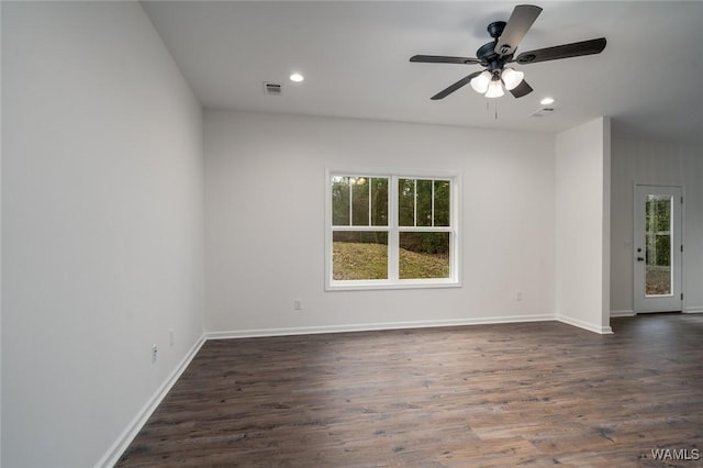 empty room with ceiling fan and dark hardwood / wood-style flooring