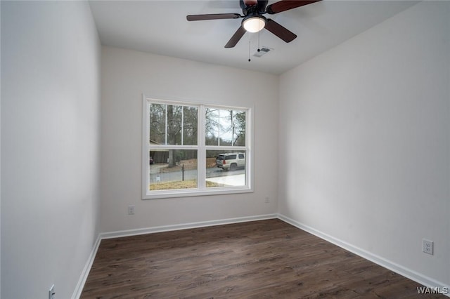 empty room with ceiling fan and dark wood-type flooring