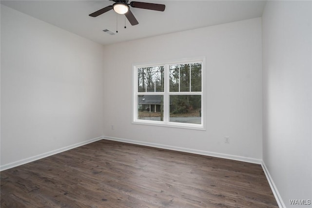 empty room with ceiling fan and dark wood-type flooring