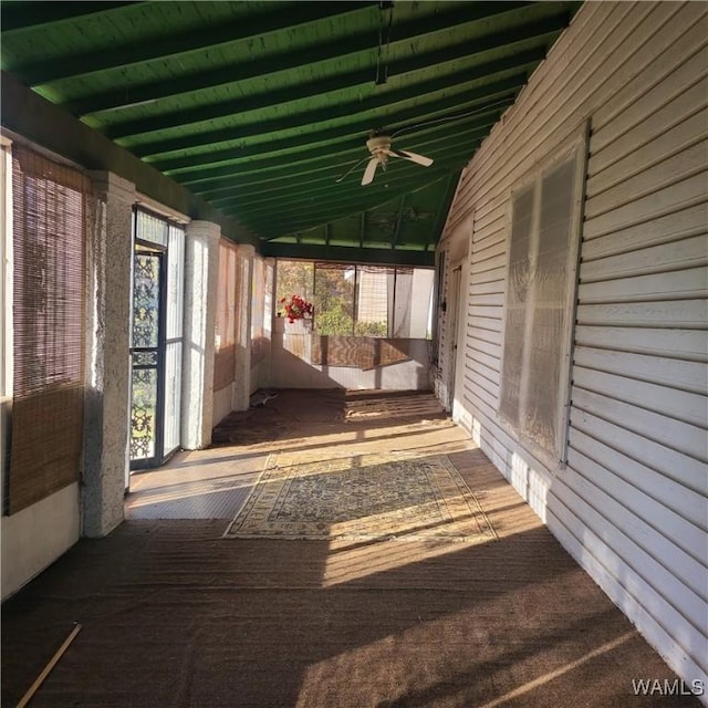 unfurnished sunroom featuring vaulted ceiling