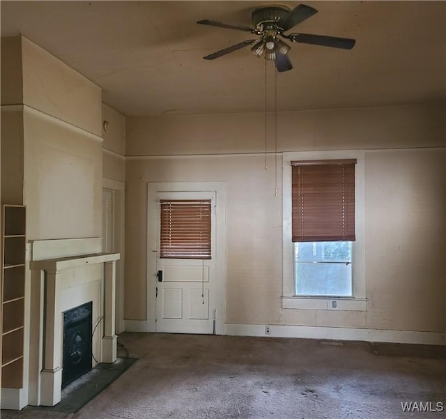 unfurnished living room featuring ceiling fan