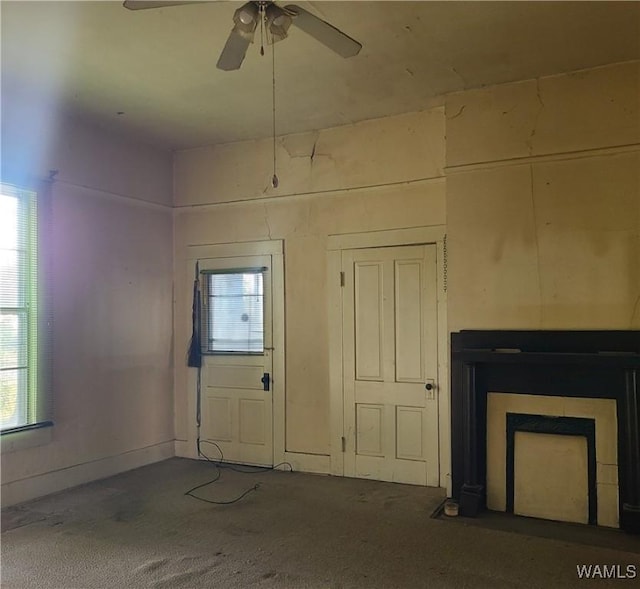 interior space with carpet and ceiling fan