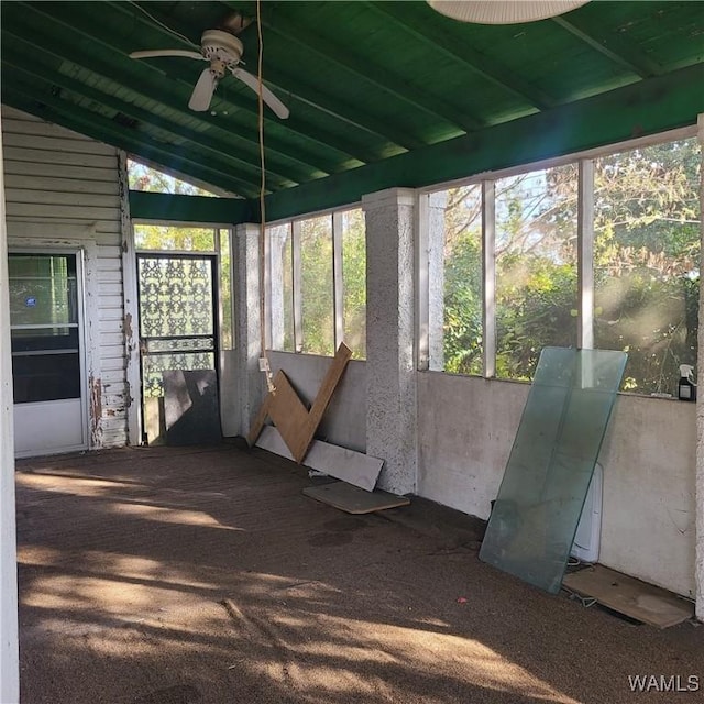 unfurnished sunroom with ceiling fan and lofted ceiling