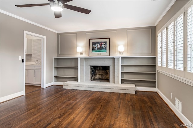 unfurnished living room with a fireplace, dark hardwood / wood-style flooring, and crown molding