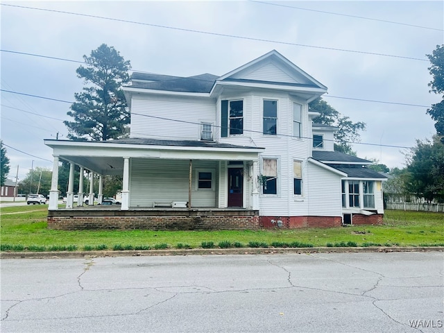 view of front of house featuring a porch and a front lawn