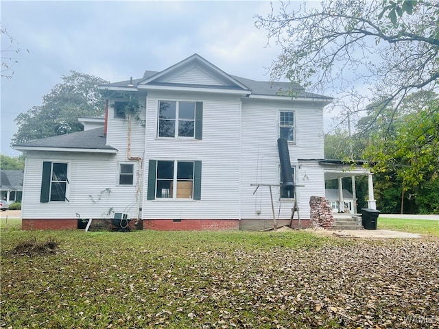 rear view of property with a lawn