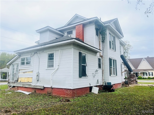 view of property exterior with a yard