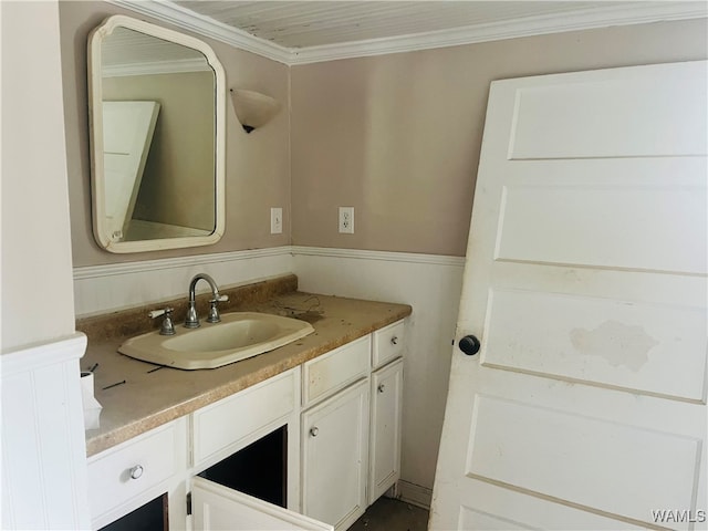 bathroom with crown molding and vanity