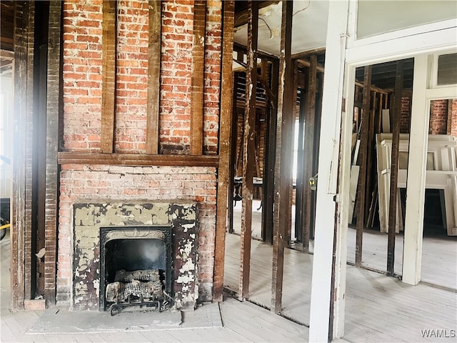 interior space featuring hardwood / wood-style floors and a brick fireplace