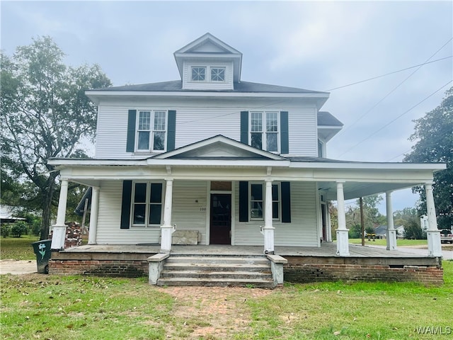 country-style home with a porch and a front lawn