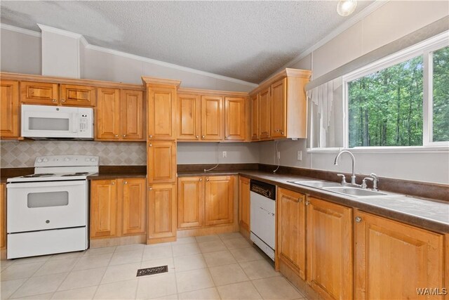 10463 Beulah Lake Ln, Cottondale, AL 35453 - kitchen featuring white appliances, lofted ceiling, a sink, ornamental molding, and dark countertops