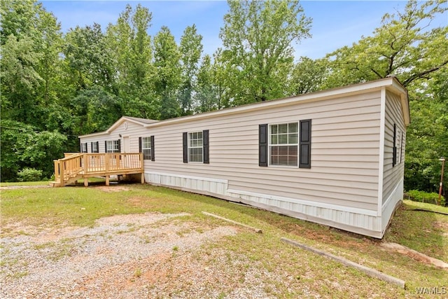 10463 Beulah Lake Ln, Cottondale, AL 35453 - view of front of property with a deck, a front lawn, and view of wooded area