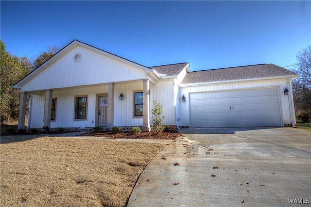 view of front facade featuring driveway, an attached garage, and roof with shingles