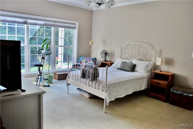 carpeted bedroom featuring a chandelier, multiple windows, and crown molding