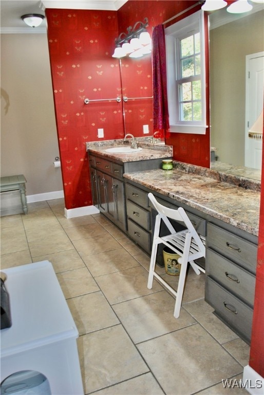 bathroom featuring tile patterned flooring, vanity, and ornamental molding