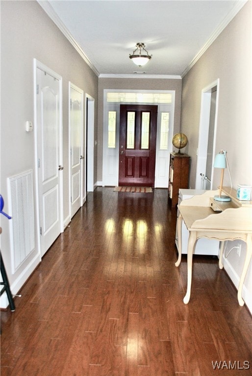 foyer entrance with crown molding and dark hardwood / wood-style flooring