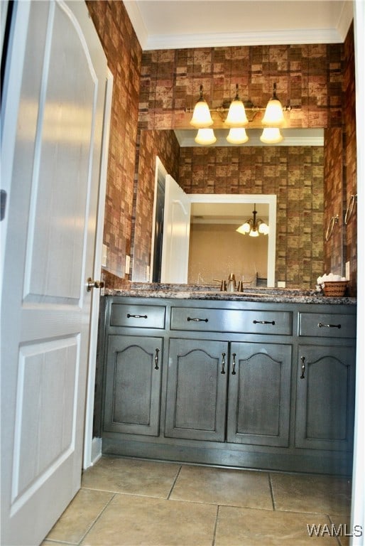 bathroom featuring a chandelier, vanity, and crown molding