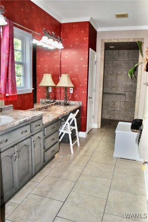 bathroom with tile patterned floors, crown molding, and vanity