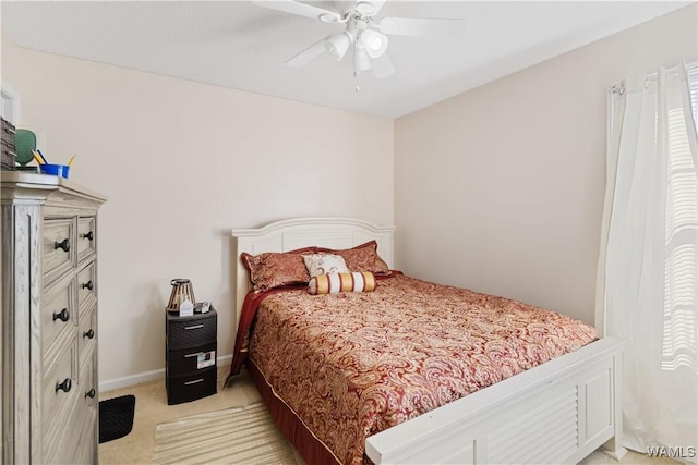 bedroom with ceiling fan and light carpet