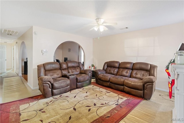 carpeted living room with ceiling fan