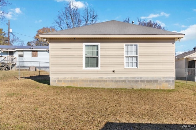 view of side of home with a lawn