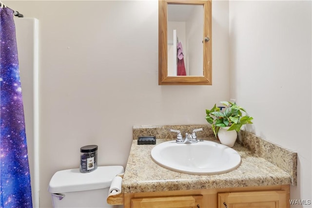 bathroom featuring vanity and toilet