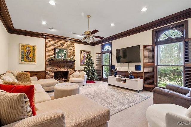 living room with light colored carpet, a brick fireplace, ceiling fan, and ornamental molding