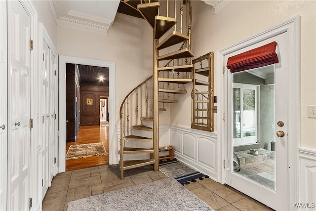 stairway featuring hardwood / wood-style flooring and crown molding