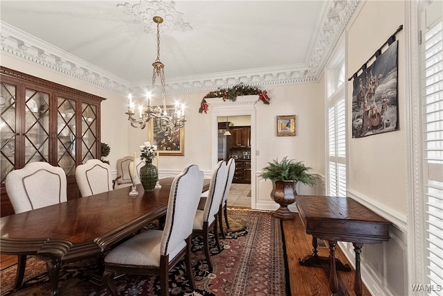 dining room featuring a chandelier, dark hardwood / wood-style floors, and ornamental molding