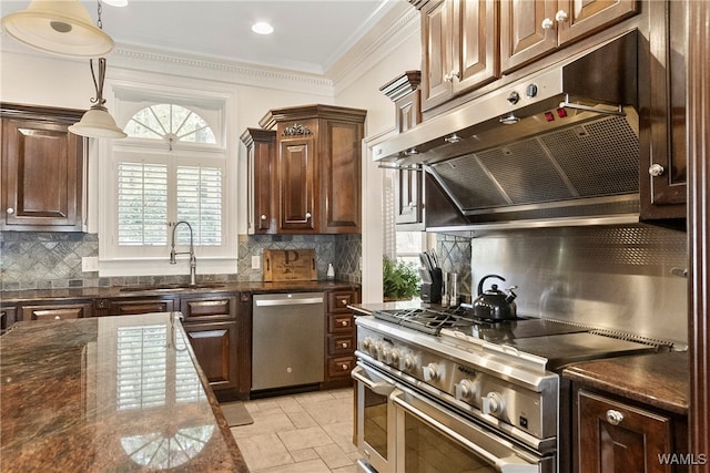 kitchen featuring ventilation hood, decorative backsplash, sink, and appliances with stainless steel finishes