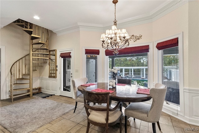 dining room with crown molding and an inviting chandelier