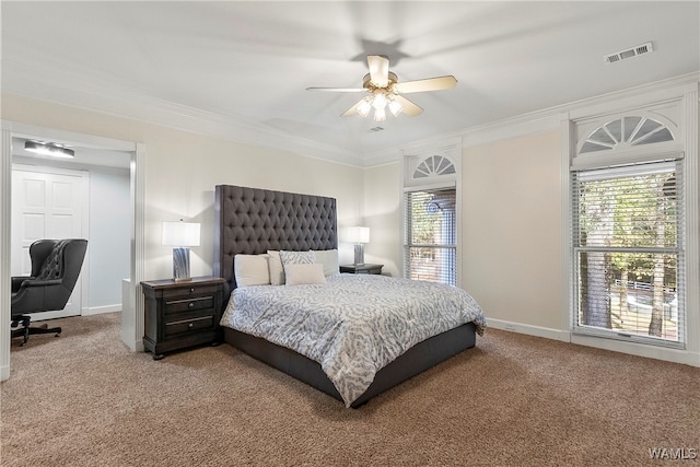 carpeted bedroom with ceiling fan and crown molding