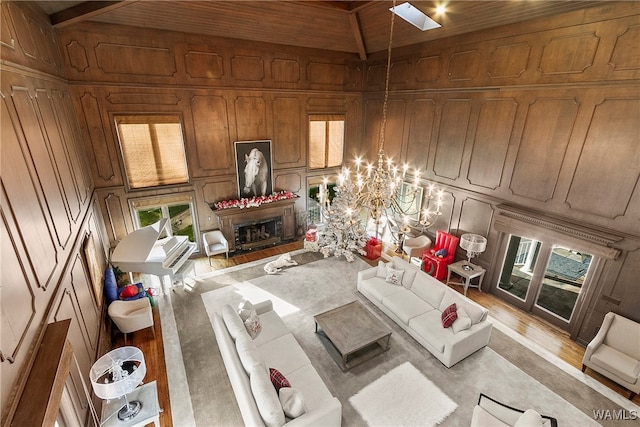 living room featuring wood walls, plenty of natural light, and light hardwood / wood-style flooring