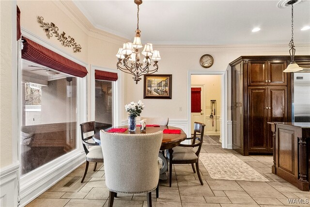 dining area with a notable chandelier and crown molding