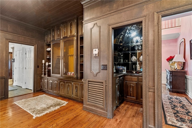 hallway with light hardwood / wood-style flooring and wooden ceiling