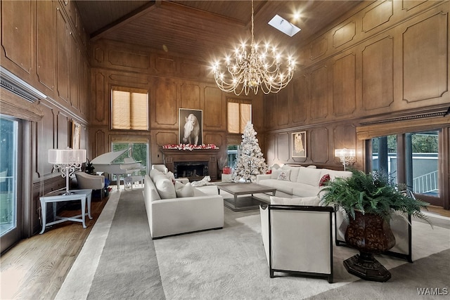 living room with wooden walls, light hardwood / wood-style flooring, high vaulted ceiling, and wooden ceiling