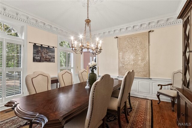 dining room with a notable chandelier, dark hardwood / wood-style floors, and crown molding